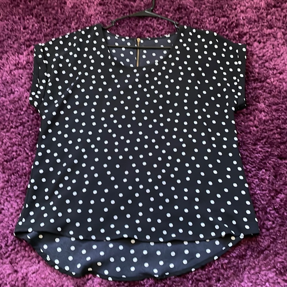 Short-sleeved, polka dots; black and white.